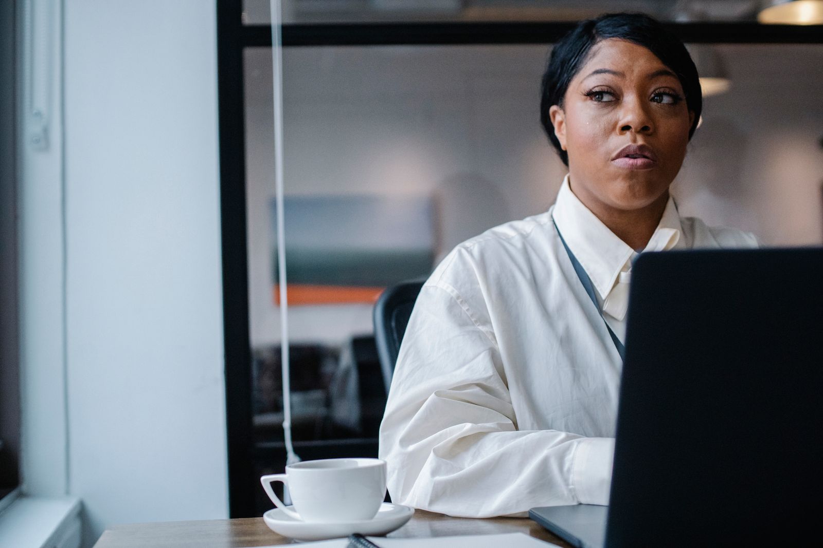 Black businesswoman working on a laptop in a professional office