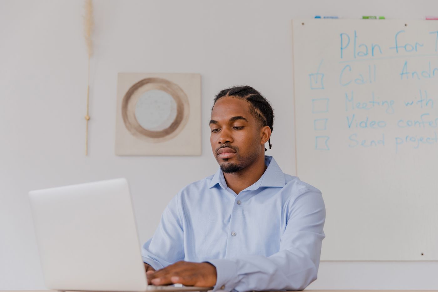 Black business owner using a laptop while planning a digital project